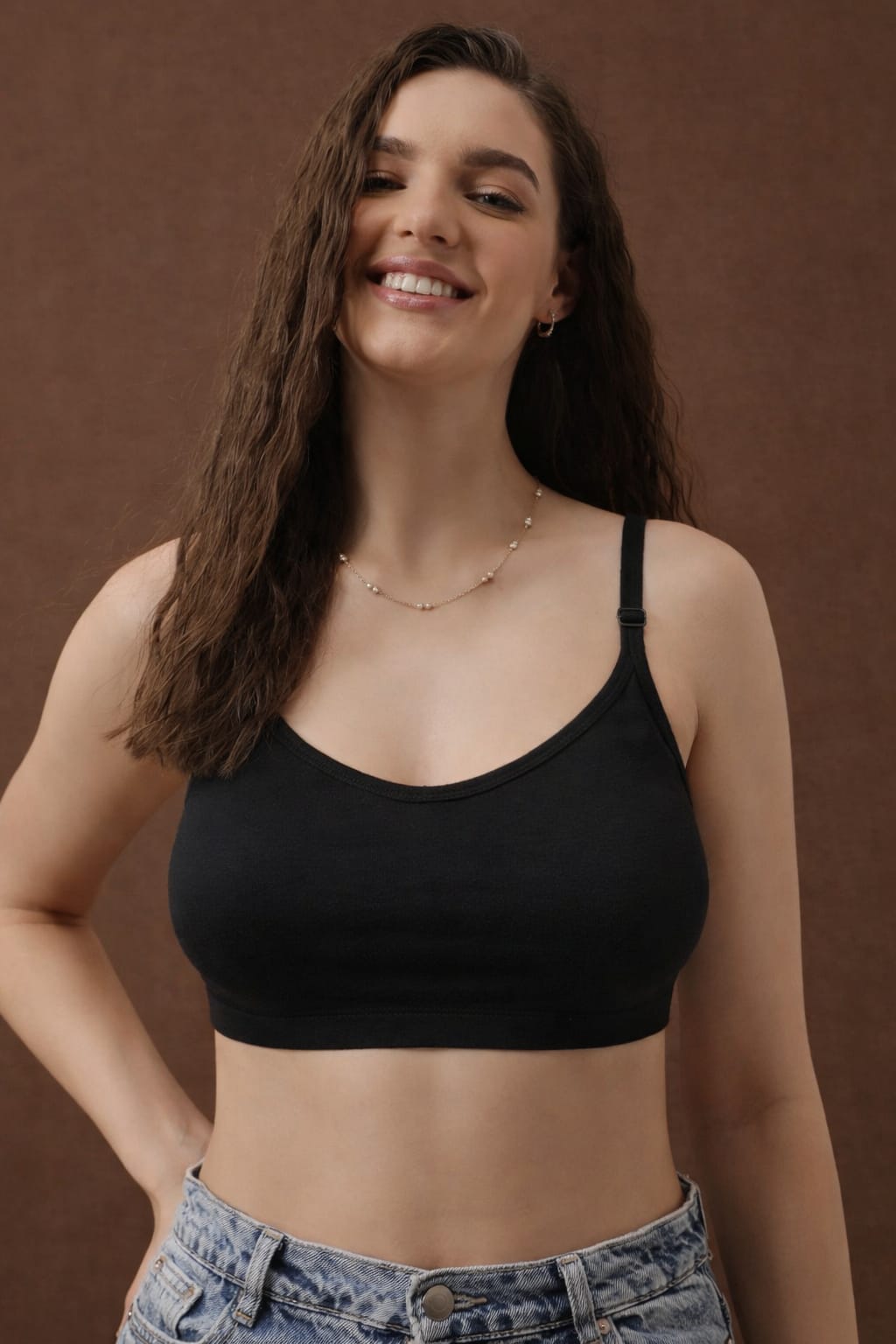Model wearing a black 100% cotton multi-way seamless sports bra in halter style